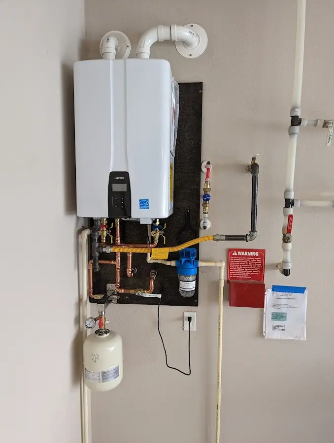 Professional plumber installing copper piping in a Louisville home